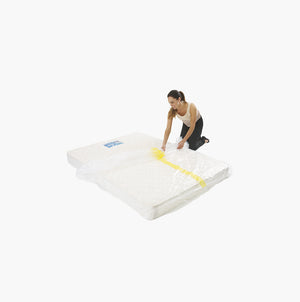 King mattress protector being placed on a mattress