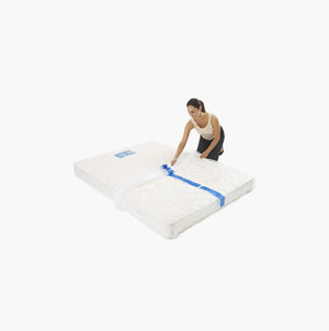 Double / queen mattress protector being placed on a mattress